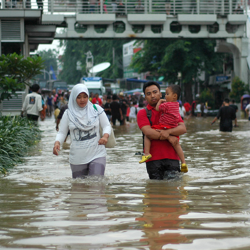 Family walking through flooded streets